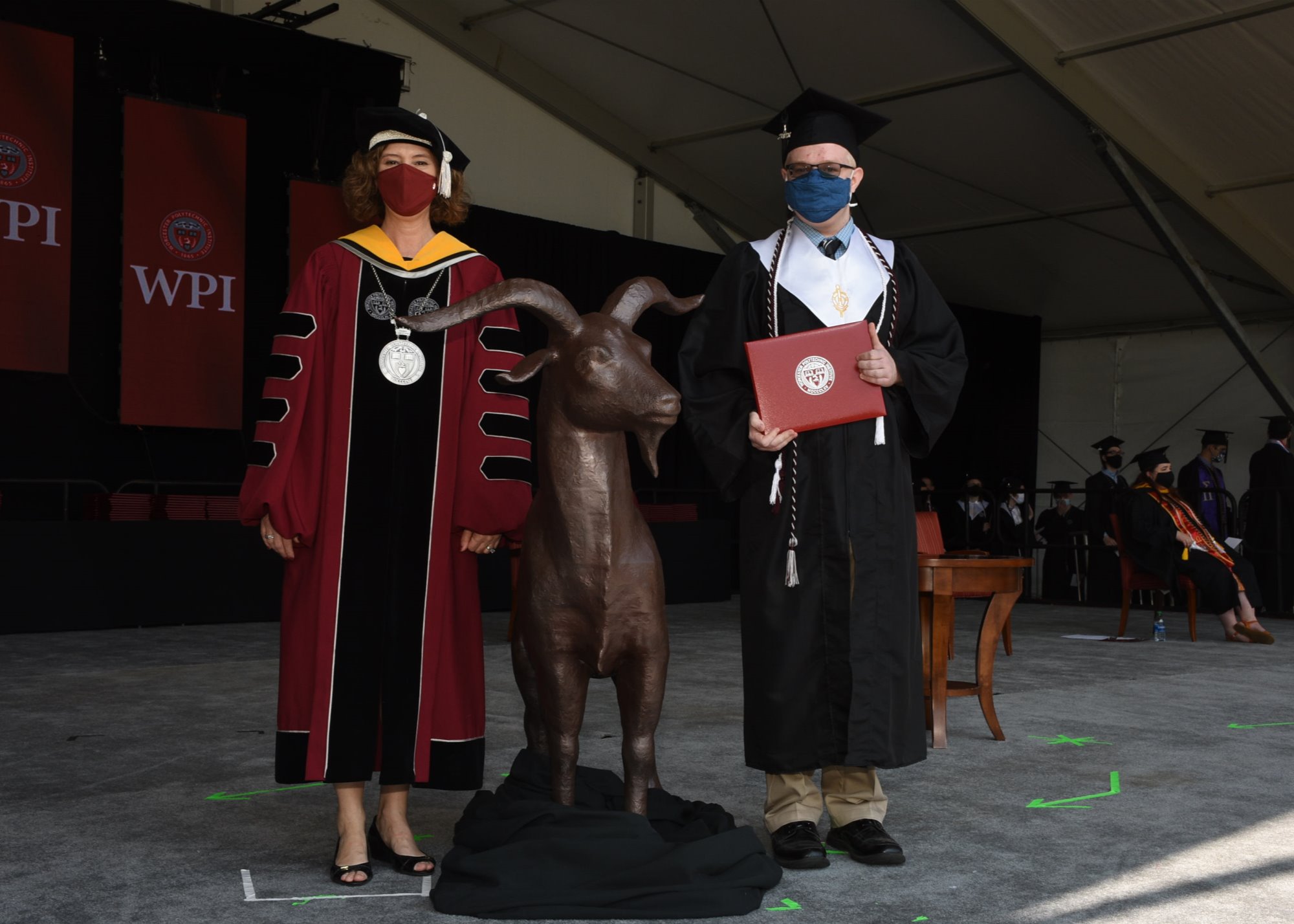 Photo at graduation with Laurie Leshin handing diploma.